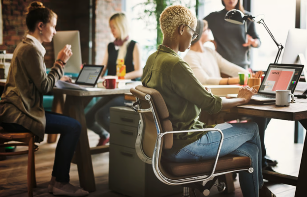 Professional team collaborating in a modern workspace, illustrating how high-speed business broadband facilitates improved productivity and seamless digital operations.