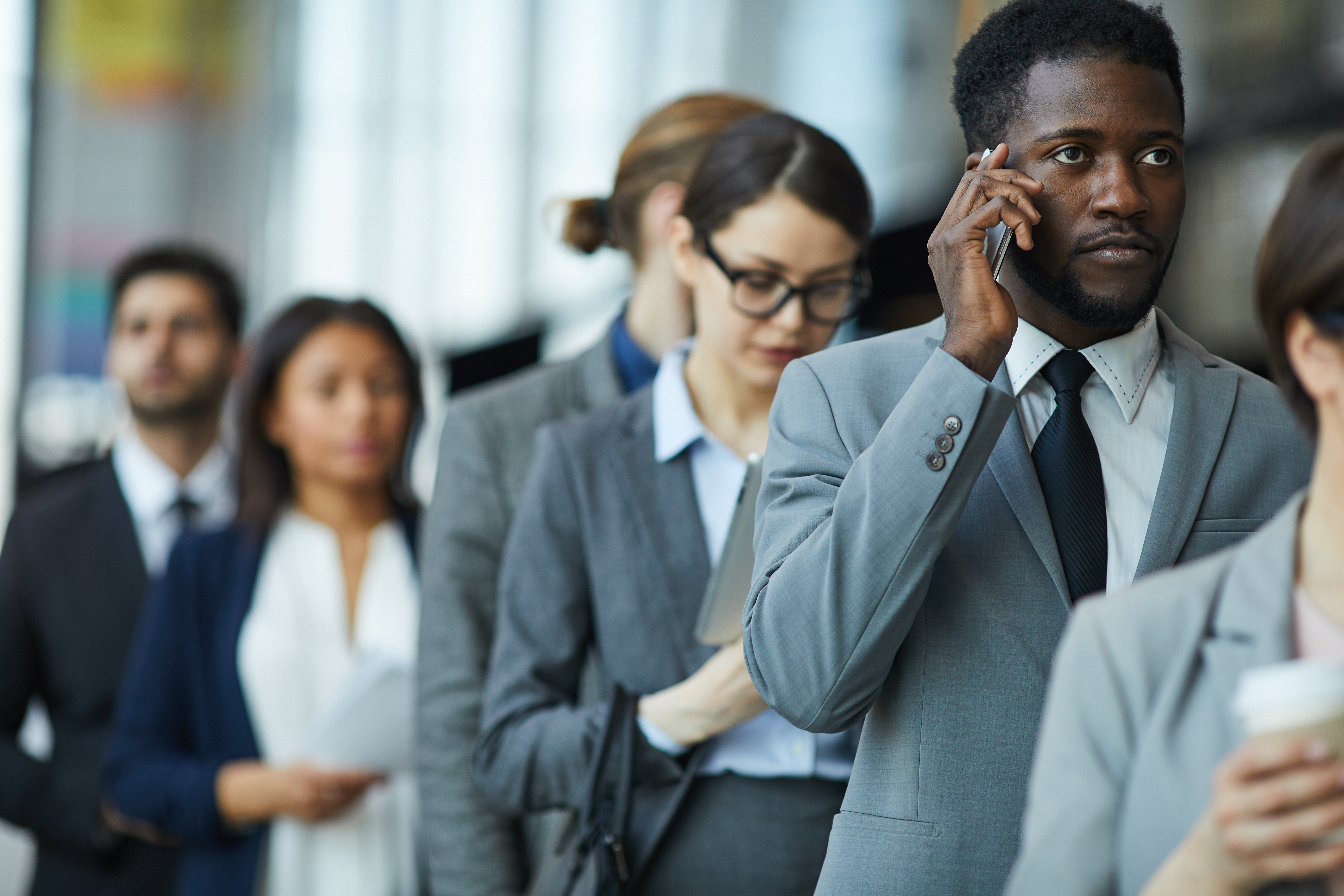 Business professionals using mobile phones on the move, showing why contract flexibility, support and reliability matter more than the headline tariff.