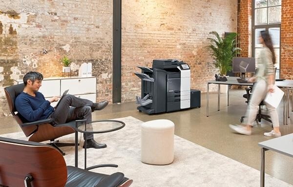 Large office printer positioned in a modern workplace for everyday business printing and document management.
